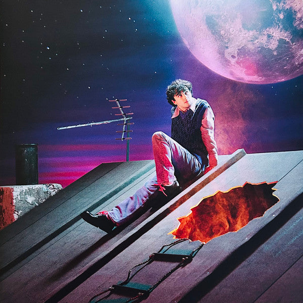 Young man sits on a rooftop with a hole revealing fire below.