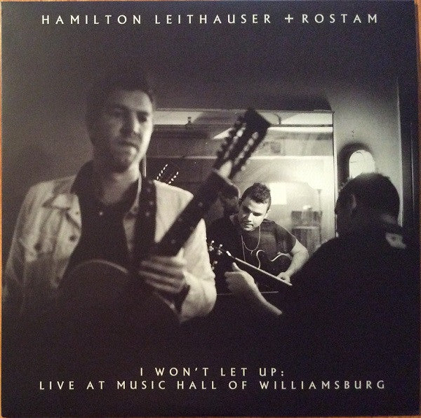 Black and white album cover featuring three musicians with guitars.
