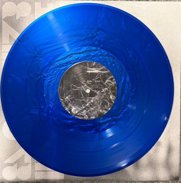 Blue iridescent vinyl record with a white label and central hole.