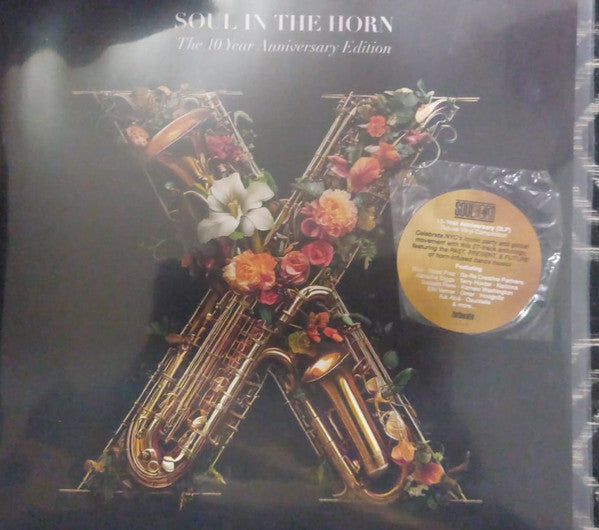 Vinyl record cover with brass instruments and floral arrangements.