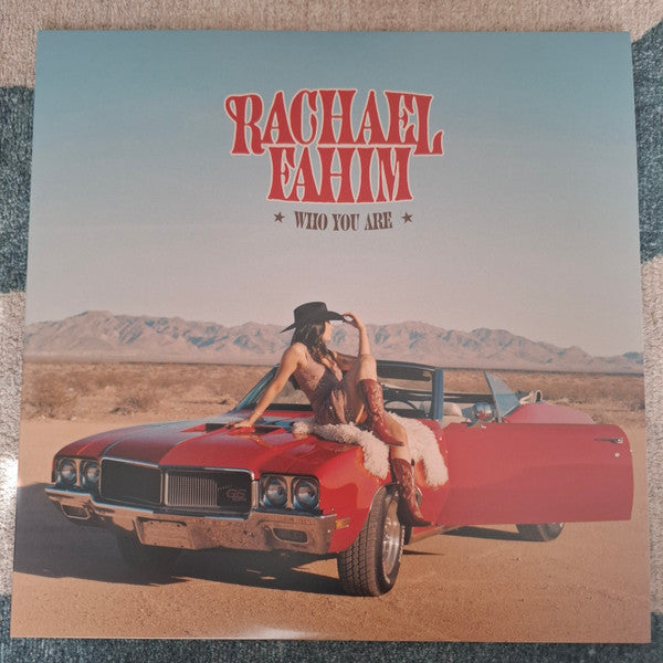 Vinyl record cover: Rachael Fahim posing with a red classic car.