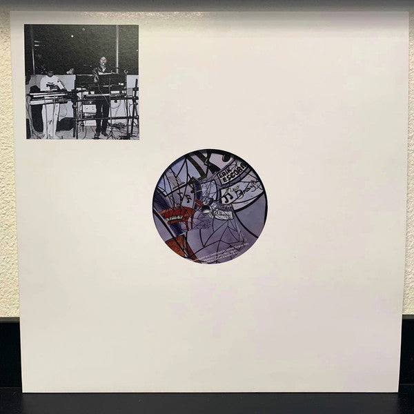 Vinyl record in a white sleeve with abstract black and white artwork.