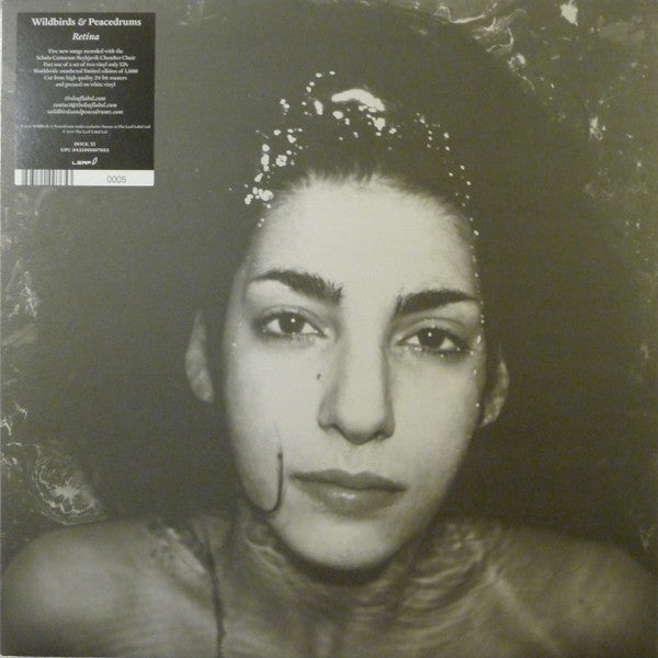 Black and white vinyl record cover featuring a close-up portrait of a woman.