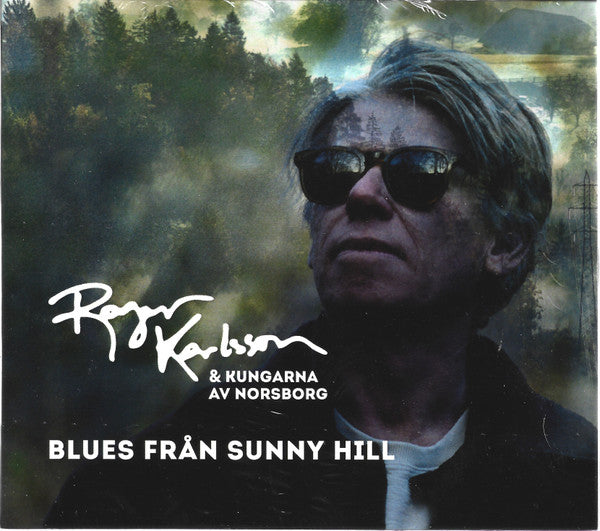 CD cover featuring a man in sunglasses with a forest background.