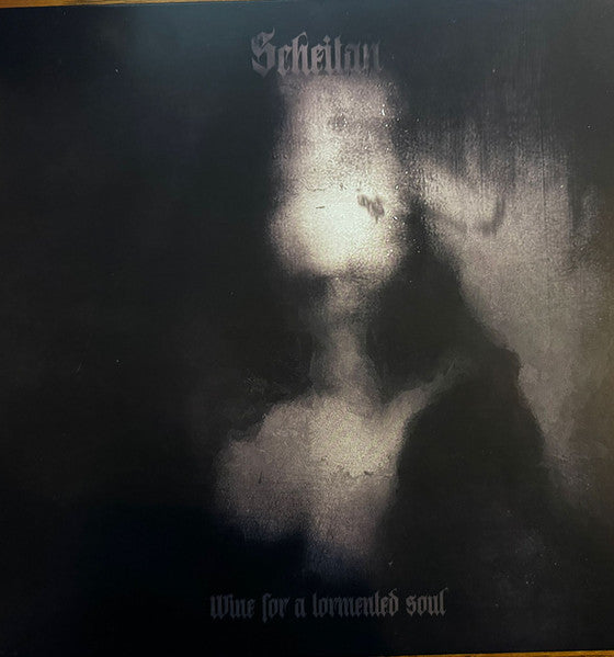Dark vinyl record cover with a blurred, ghostly figure and text.