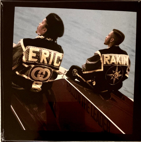 Eric B. and Rakim sitting on a boat, wearing jackets with their names.