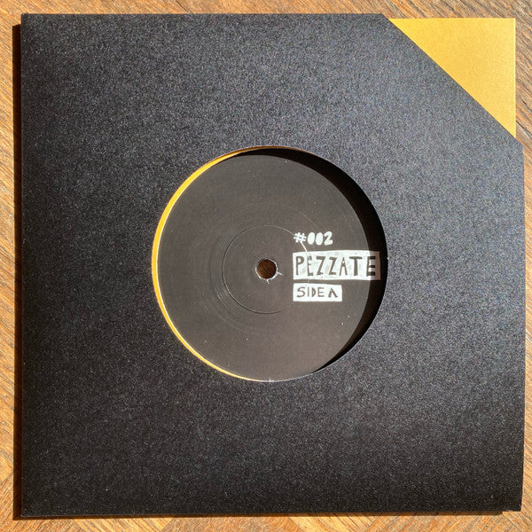 Black vinyl record in a black sleeve with white label text.