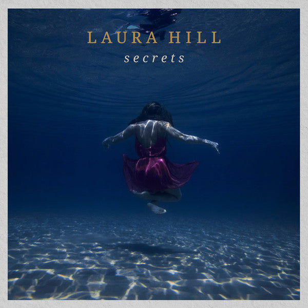 Laura Hill's "Secrets" CD cover: woman submerged in blue water.