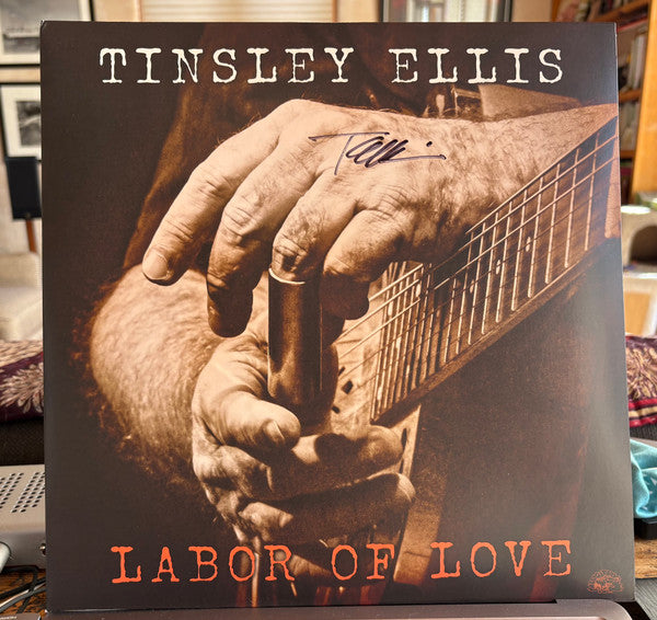 Vinyl record album cover with hands playing guitar, titled "Labor Of Love".