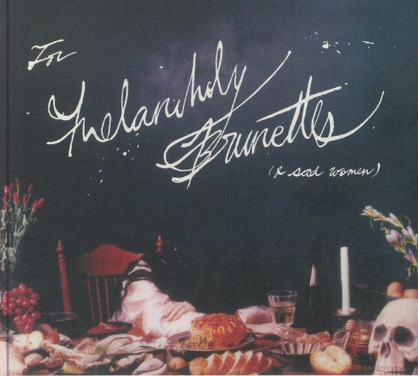 CD cover with handwritten text, skull, and still life arrangement.