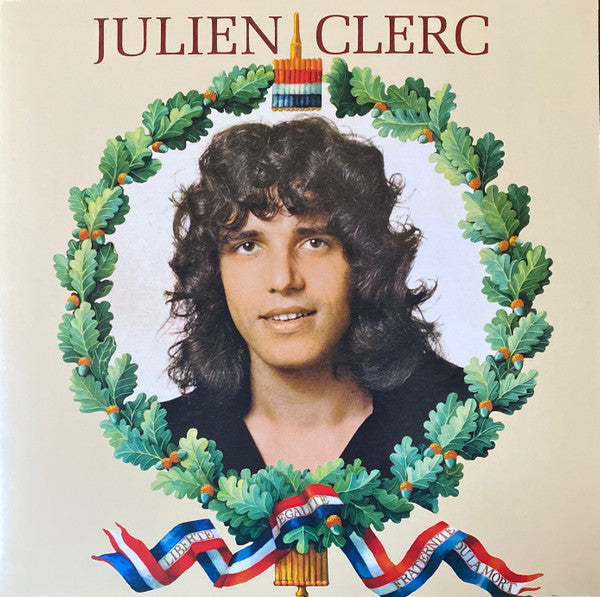Vinyl record cover featuring Julien Clerc with a laurel wreath frame.