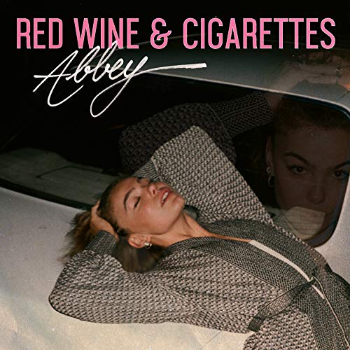 "Album cover with a woman reclining in a car, smoking a cigarette."
