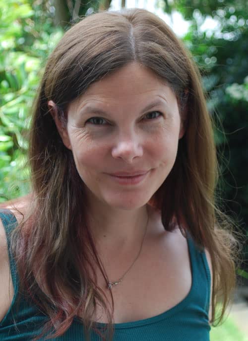 Woman with shoulder-length brown hair smiling at the camera.