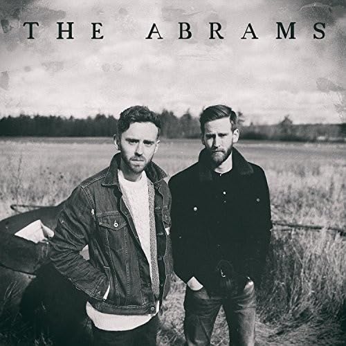 CD cover featuring two men in a field under a cloudy sky.