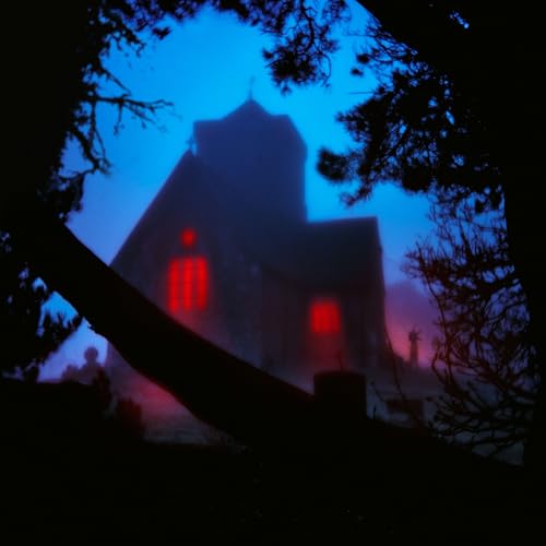 Dark, misty image of a house with glowing red windows.