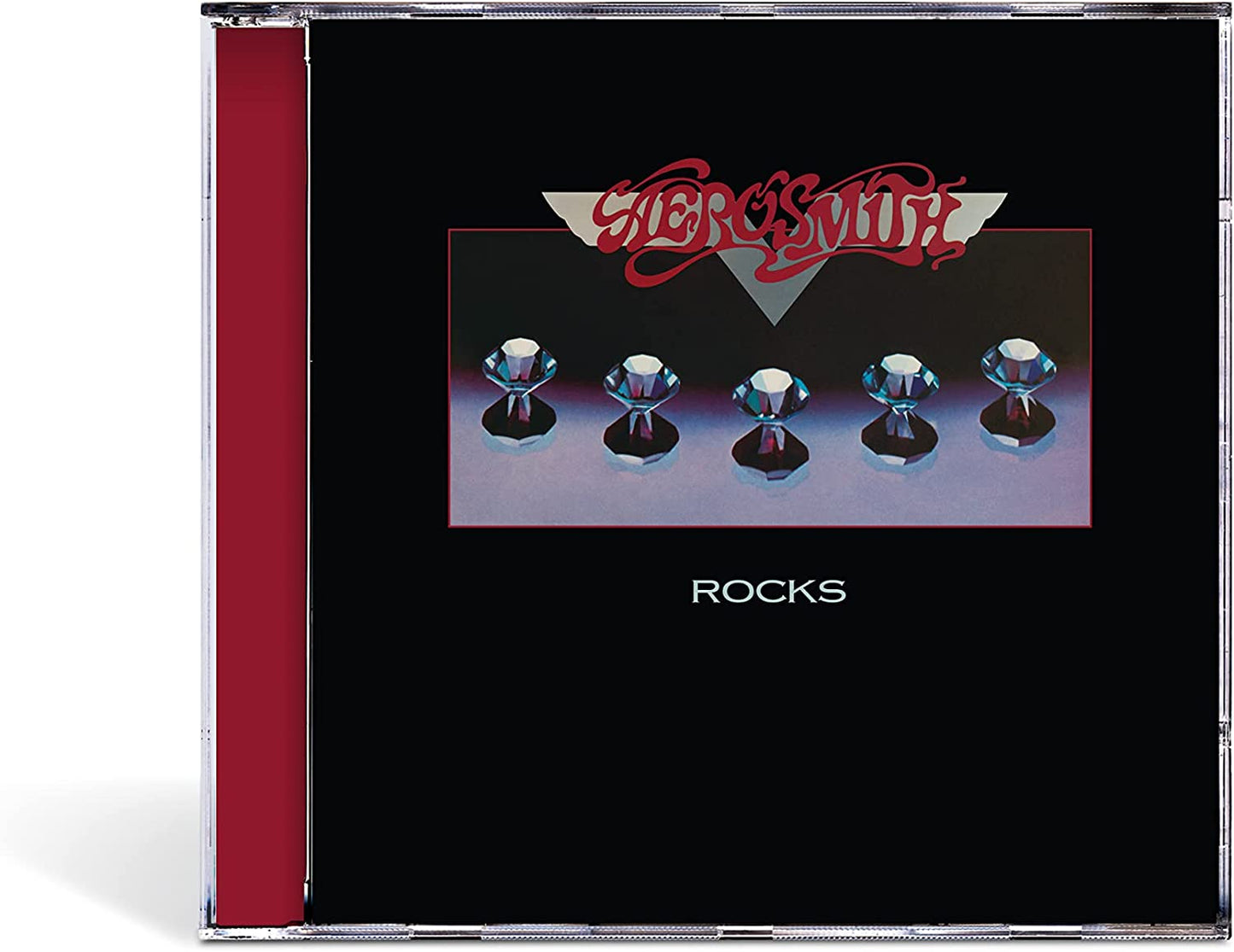 Aerosmith “Rocks” CD case with gem-topped knobs on a dark background.