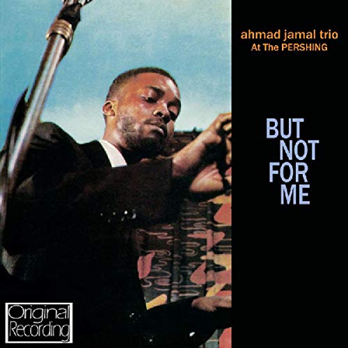 Ahmad Jamal album cover: portrait of a man with a microphone, black background.