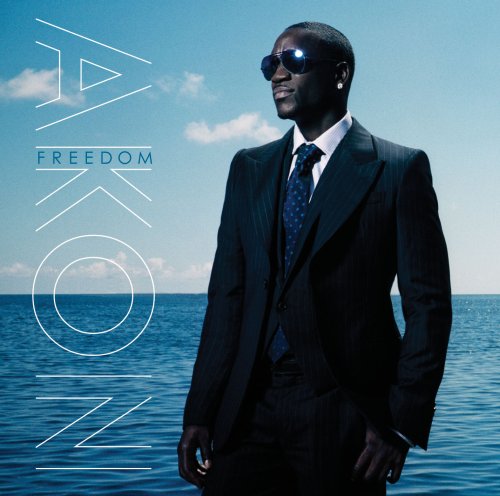 Akon in a suit standing by water, "FREEDOM" album cover art.