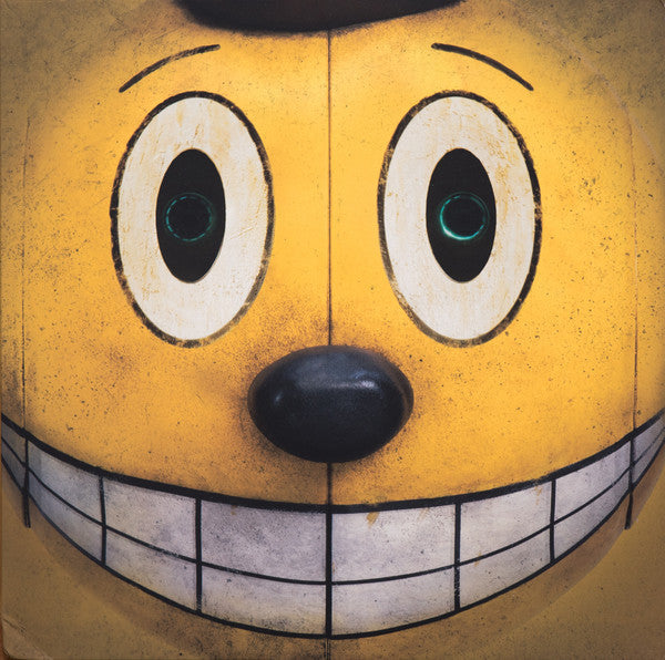 Yellow robotic face with large eyes and a smiling mouth.