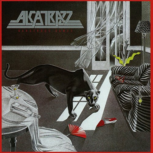 A black panther prowls through a room with zebra-striped furniture and a red fan.