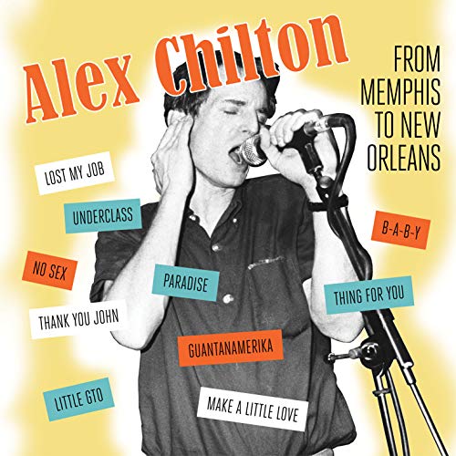 Black and white photo of Alex Chilton singing into a microphone on yellow background.