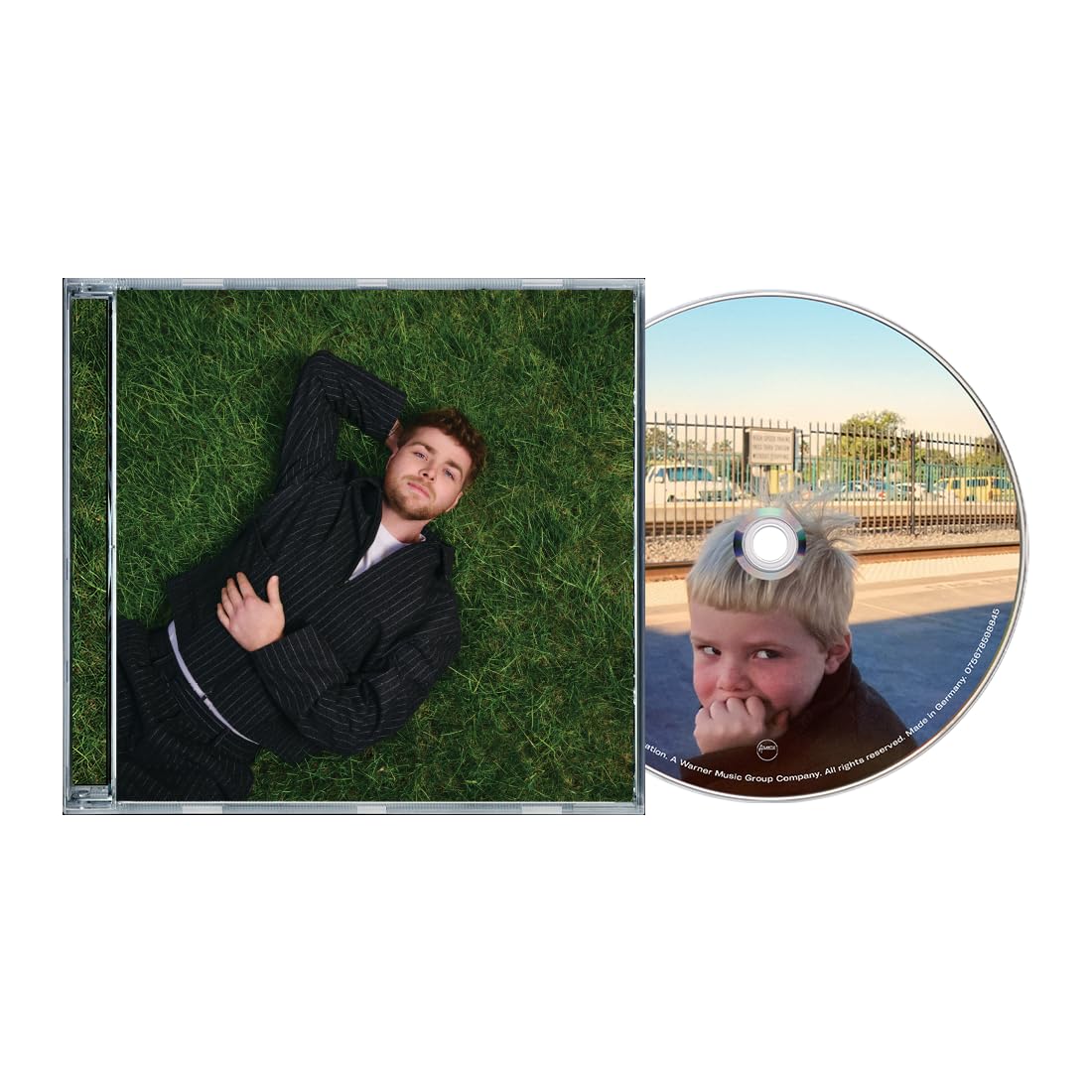 CD case featuring a man in a suit lying on artificial turf.