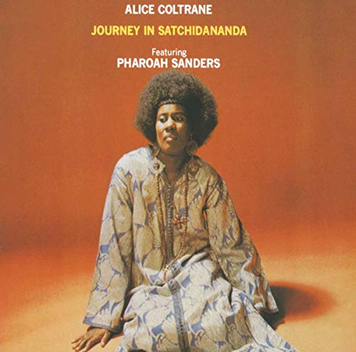 Album cover featuring Alice Coltrane in a patterned robe against an orange background.