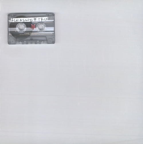 A grey cassette tape with the band name written on it against a white background.