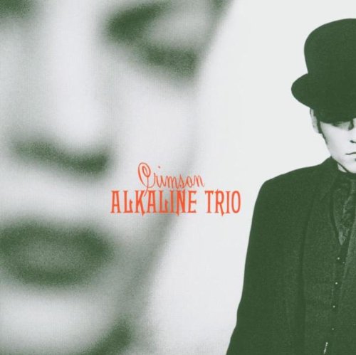 Album cover featuring a man in a bowler hat and a blurred face.