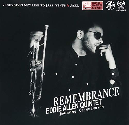 Black and white portrait of Eddie Allen holding a trumpet against a dark background.