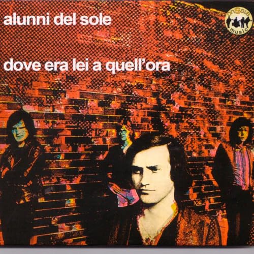 CD cover with a group of people in front of a brick wall.