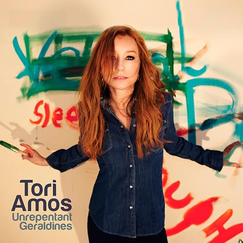 Tori Amos portrait with colorful abstract paint splatters in background.