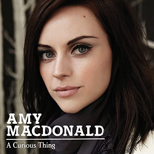 Amy Macdonald album cover, close-up portrait of a woman with dark hair.