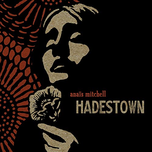Hadestown" CD cover featuring a textured profile and floral design.