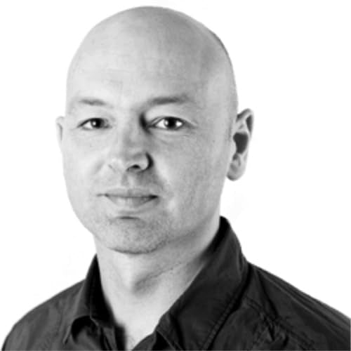 Black and white portrait of a bald man with a jacket.