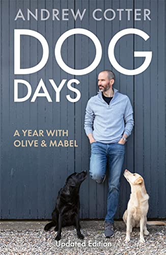 Book cover with a man and two dogs, a black lab and golden retriever.