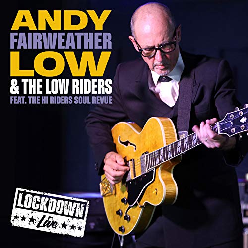 Andy Fairweather Low playing a golden electric guitar on stage.