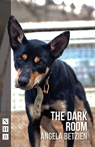 Book cover: a black and tan dog with a blurred kennel background.