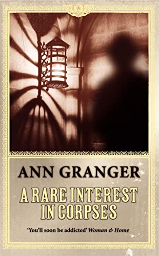 Book cover: dark alley scene with lantern, title “A Rare Interest in Corpses.”