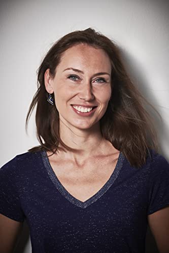 Headshot of a smiling woman with long brown hair and blue eyes.