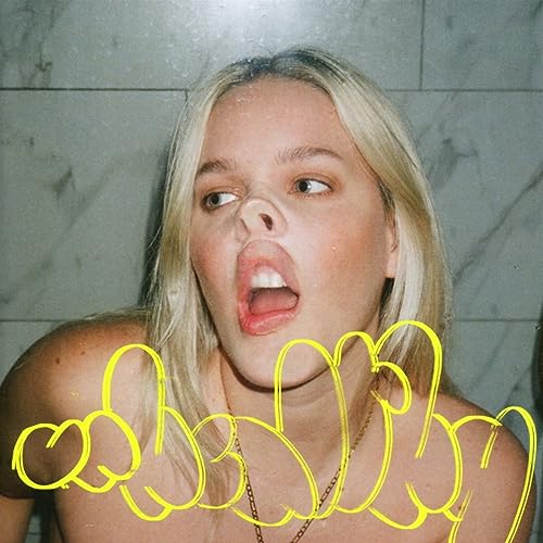 Close-up of Anne-Marie with open mouth and yellow scribbles.