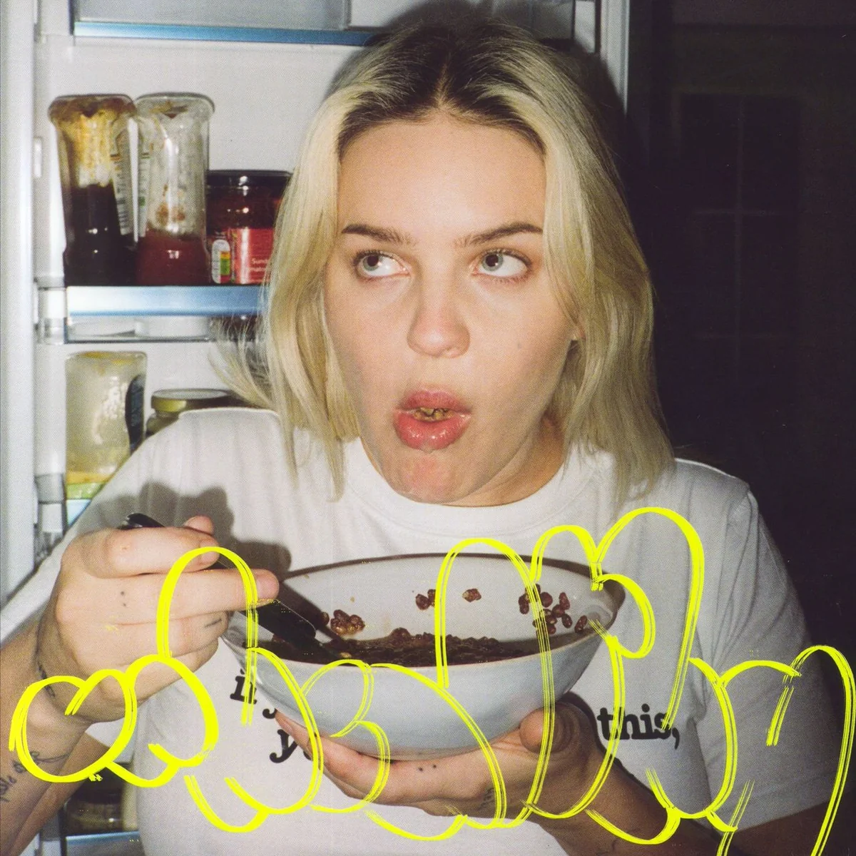 Anne-Marie with a bowl of cereal, looking at the camera.