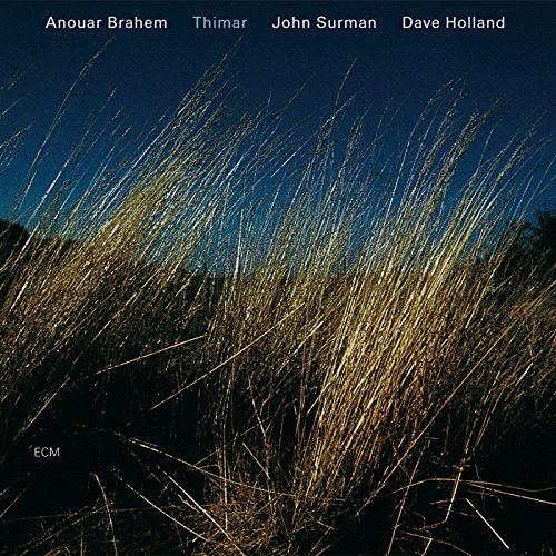 CD cover with a golden field of grass against a blue sky.