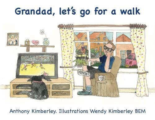 A man sits in an armchair watching television while a black dog sits nearby.