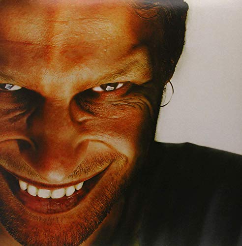 Close-up of a man’s face with a wide smile, vinyl record cover.