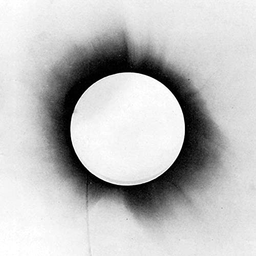 Black and white album cover with a bright circular center.