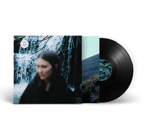 Vinyl record with album cover featuring a woman near a waterfall.