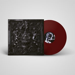 Black vinyl record and ornate black album cover with a face detail.