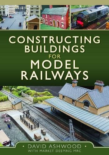 Book cover showing model railway buildings, a train, and station scenery on a green background.
