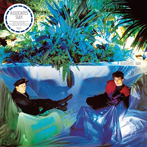 Album cover for Associates’ “Sulk” featuring two figures amidst blue foliage.